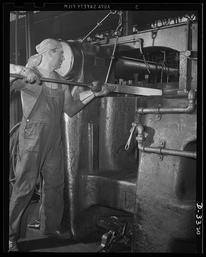 A husky upsetter and a forge that was turning out automobile parts a short time ago is one of the many combinations of skilled worker and efficient machine that keep the shells pouring in a steady stream from a converted auto plant. Oldsmobile, Lansing, Michigan