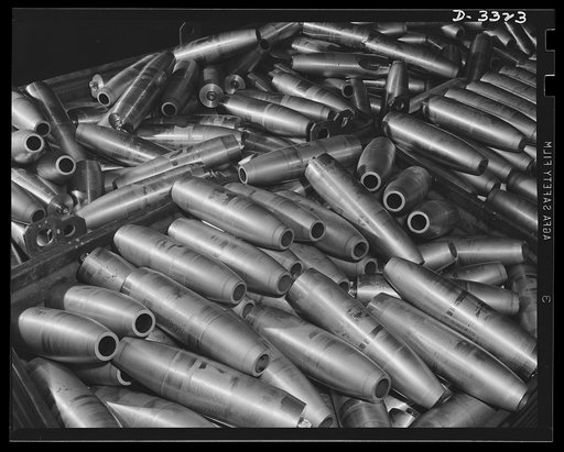 America's huge production machine is really rolling now. A plant that was producing a popular car a short time ago is now operating even more efficiently on the manufacture of shells for the Army. Oldsmobile, Lansing, Michigan