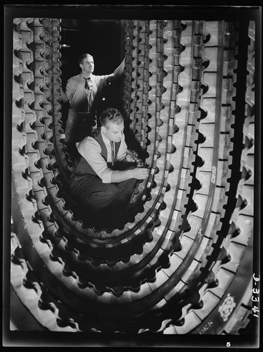 Tracks for Army halftrac cars must undergo a careful inspection and be approved before they can be released from the production line of a Midwest tire plant. Goodrich, Akron, Ohio