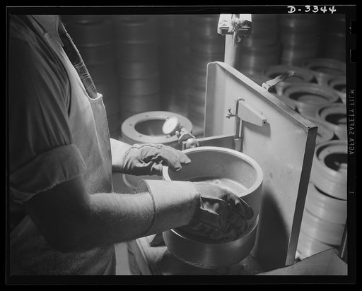 Steel bases for the bogie wheel assemblies of Army halftrac cars are inspected in a Midwest tire plant. Accurate gauging is necessary to insure positive fit in molds and in wheel assemblies. Goodrich, Akron, Ohio