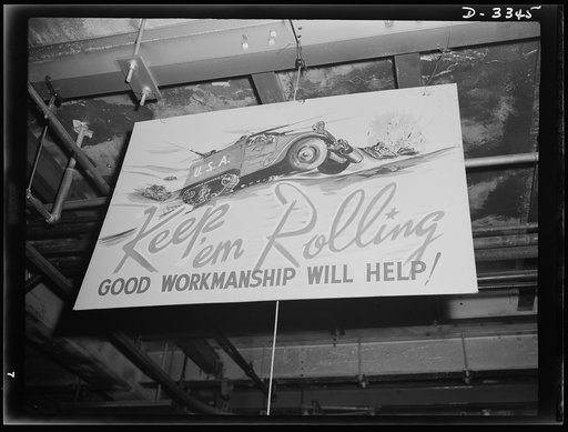 The halftrac production department of an Ohio tire plant now handling a large Army order displays a poster that expresses the sentiments of the management and the workers. Goodrich, Akron, Ohio