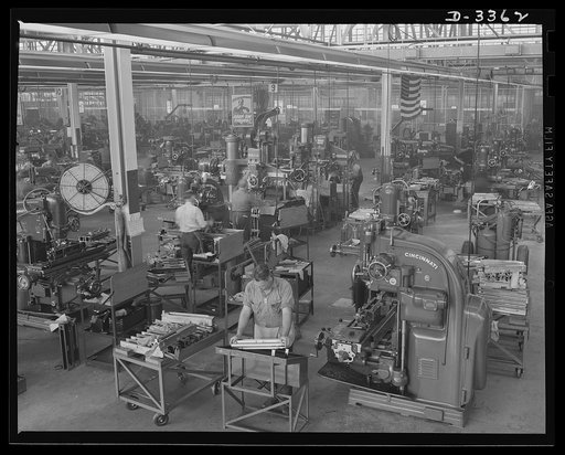 Twenty-millimeter machine guns for planes. A big automobile plant, now entirely on war production, has a well-equipped department for the finishing of breeches for Air Corps machine guns. Milling, grinding and other machine operations are handled as expertly as in the days when the plant was making 
