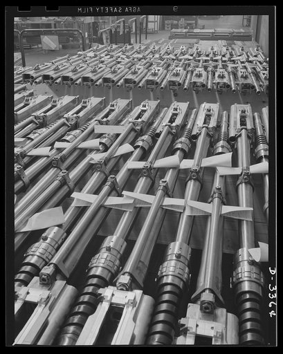 Twenty-millimeter machine guns for planes. American power in the air grows rapidly as machine guns of the finest quality pour from our production lines to arm the planes that are coming steadily from other lines. These guns, entirely completed and ready to fire, await shipment from the large convert
