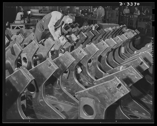 Bofors forty-millimeter mounts. A plant inspector carefully checks welded gun carriages for Bofors forty-millimeter anti-aircraft guns. These carriages and Bofor gun mounts are now manufactured in a large Midwest rubber company which has been converted to production of war necessities. Originally, B