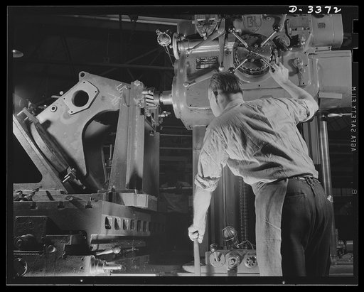 Bofors forty-millimeter mounts. The final operation in the manufacture of gun carriages for the Bofors forty-millimeter anti-aircraft guns is taking place on this horizontal milling machine. A workman of a large Midwest rubber company converted to war production is milling the top bearing trunion pa