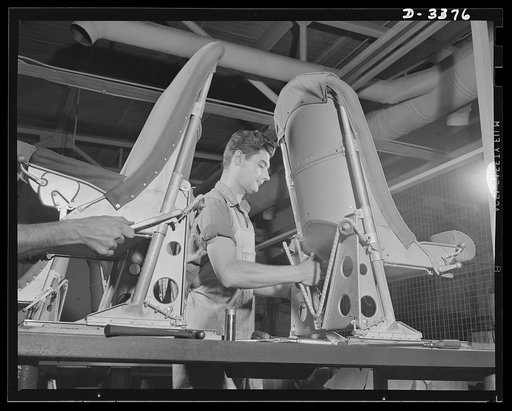 Airplane seat production. See the "V" on the airplane pilot seat? It's the Victory elastic cord which provides the stress needed to counter-balance the pilot's weight during vertical adjustment of the seat. An inspector employed by a large Midwest rubber company now converted to production of war es