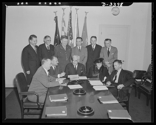 Paul V. McNutt, Chairman of the War Manpower Commission, calls the first meeting of the Commission on May 6, 1942. The committee members seated from left to right are: Donald M. Nelson, War Production Board (WPB); Claude R. Wickard, Agriculture Department; V. McNutt, Federal Security Agency; Francis