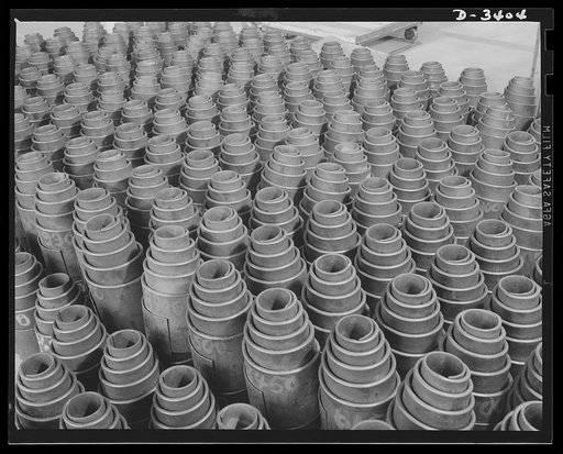Conversion. Heaters to bogie wheels. Ready for final assembly, these bogie wheel springs have been stacked in the erstwhile warehouse of a Midwest heater factory. These springs are fitted into bogie wheel assemblies for Army M-4 tanks