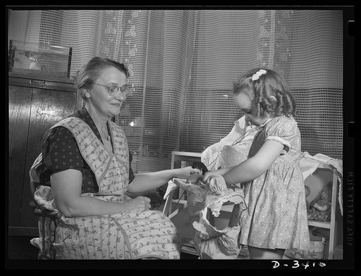 Women at war (Mrs. Smuda). Like any other grandmother, skilled worker Eva Smuda enjoys the "children's hour" each day. And her work at the Frankford Arsenal never leaves her too tired for those games of make-believe with five-year-old Barbara