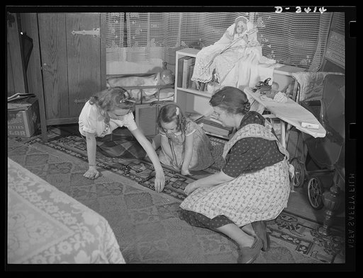 Women at war (Mrs. Smuda). A full-time job at the Frankford Arsenal and a full-time job of housekeeping and still this modern American mother finds time to play with grandchildren