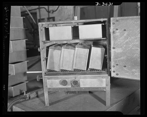 Conversion. Metal screens to bomber windows. An electric furnace preheats aluminum junction boxes to speed welding at an Eastern plant engaged in war production. The plant formerly made metal screens for doors and windows