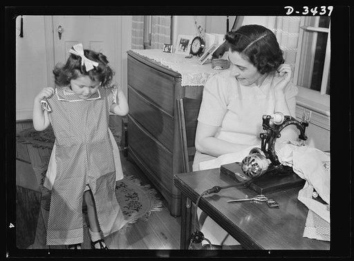"How do I look?" Attractive playsuits for daughter can be made from that old housedress with the splitting seams, and junior's first long pants (no cuffs) can be cut from father's old overcoat. With shortage of wool and other materials needed by the armed forces, it's a wise mother who conserves clo