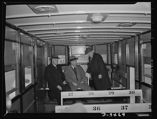 New oversize trailer for war workers. Inspecting the new oversize bus trailer, made almost entirely of non-critical materials, are two of the men who were instrumental in its construction, Joseph B. Eastman (left), director of the Office of Defense Transportation and Frank H. Shepard (right) of the 
