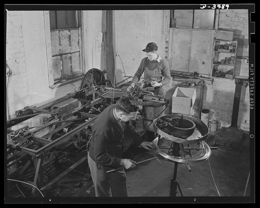 Conversion. Toy furniture to dies for incendiary bombs. This small Midwest machine shop used to manufacture doll's furniture and fly swatters before Pearl Harbor. Today, busy with subcontracts on war production orders, they're hurrying the last lengths of swatter-wire off the machines. Circular mach
