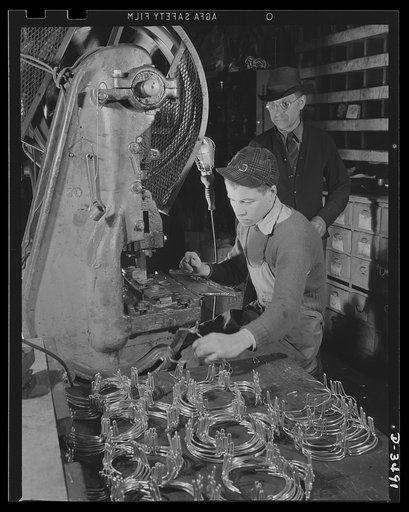Conversion. Toy furniture to dies for incendiary bombs. This small Midwest machine shop used to manufacture doll's furniture and fly swatters before Pearl Harbor. Subcontracts on defense orders now occupy all machines as rapidly as the old stock can be assembled. Here two high school boys complete m