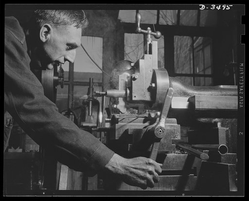 Conversion. Toy furniture to dies for incendiary bombs. This milling machine formerly used in producing metal furniture for doll houses, has a much more important task these days. It's scraping steel plate to be used in bomb dies. Location: a small factory, somewhere in the middle west. Sivon Machin