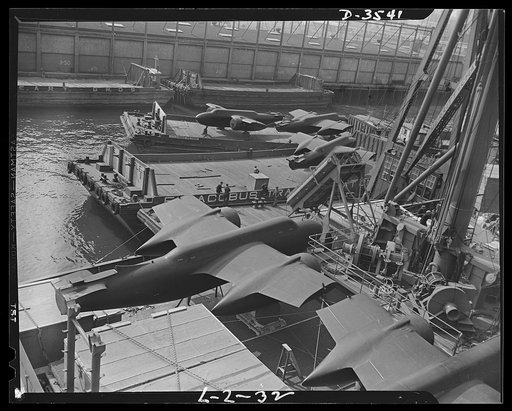 Lend-lease shipments from the United States. Heavy bombers on barges awaiting loading onto cargo vessel in New York harbor under provisions of the lend-lease