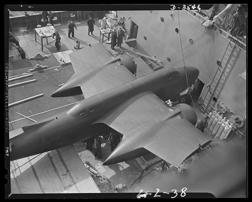 How lend-lease strikes at the Axis. Parts of this twin-engine plane's wings have been removed before the plane is hoisted aboard a ship being loaded at an Atlantic coast port with American arms for one of the United Nations