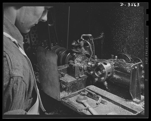Conversion. Watch cases to war production. Keeping the chips flying. An automatic screw machine that was turning watch case crowns a year ago now works on bomb fuse baffles as a large Kentucky factory goes entirely on war Production. Wadsworth Watch Company, Louisville, Kentucky