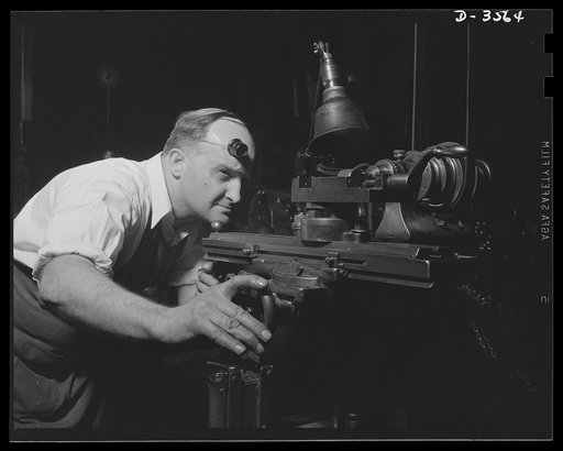 Conversion. Watch cases to war production. Sighting one of the "guns" of production. A diemaker in a converted Kentucky watch case factory sets his machine for the production of fine parts for carbines, machine guns and military radios. Wadsworth Watch Company, Louisville, Kentucky