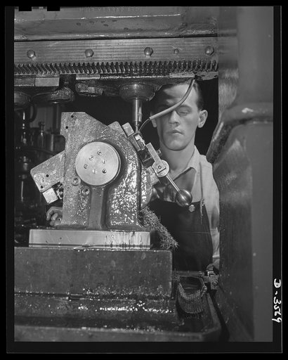 The mouthpiece of a 20mm anti-aircraft gun magazine requires many milling machine operations. Heavy production of these magazines is the order of the day at a large plant that had been making cash registers. National Cash Register Company, Dayton, Ohio