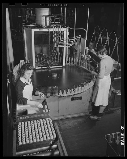 Conversion. Cash registers to gun magazines. A machine paints the exterior and interior of each 37mm M-54 high explosive shell made at a former cash register factory now engaged in war production. National Cash Register Company, Dayton, Ohio