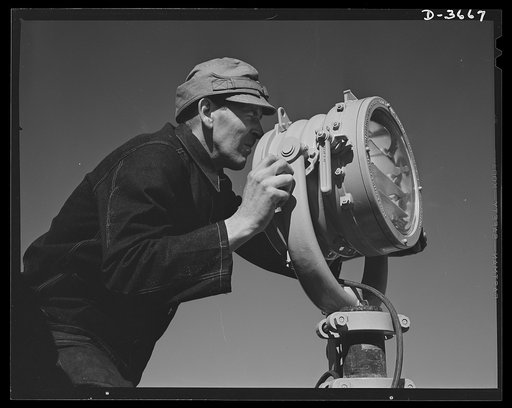 Fort Story coast defense. It takes a keen eye and a steady hand to operate a signal lamp which speeds incoming vessels to shore
