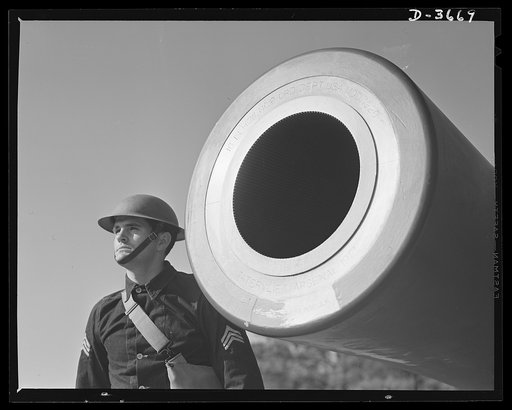 Fort Story coast defense. A sergeant of the CAC [coast artillery Corps?] stands beside the muzzle of a sixteen inch howitzer at Fort Story, Virginia