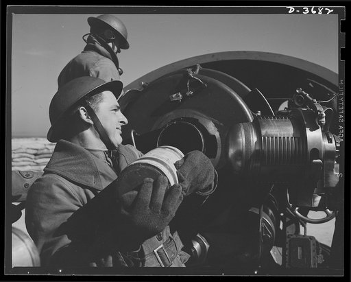 Fort Story coast defense. A husky soldier at Fort Story, Virginia hoists a round to the breech of a coast defense gun
