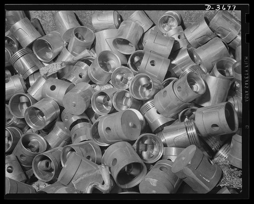 Rejected for slight imperfections, these piston duds will be dumped back into the furnace of a huge Midwest aluminum factory for recasting. Aluminum Industries