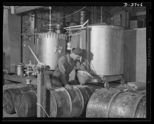 Aluminum paint production. Filling drums of paint from mixers into tarred drums on scale. Site of this operation is a large Midwest aluminum factory producing war essentials for the Army. Aluminum paint is a civilian scarcity these days, but Uncle Sam still uses lots of it