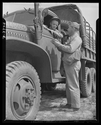 Mrs. Smuda's son. He used to drive a bakery wagon, but now he drives a truck for Uncle Sam. Private Edwin Smuda at camp "somewhere in the South" is one of America's many fighting men with mothers who are working just as hard for Victory as they are. Mrs. Eva Smuda, fifty-five, works eight hours a da