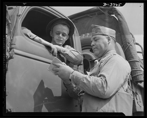 Mrs. Smuda's son. He used to drive a bakery wagon, but now he drives a truck for Uncle Sam. Private Edwin Smuda at camp "somewhere in the South" is one of America's many fighting men with mothers who are working just as hard for Victory as they are. Mrs. Eva Smuda, fifty-five, works eight hours a da