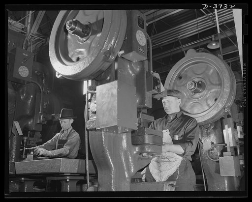 Punching out the jeeps. Parts for these hard-boiled little army cars are punched out on presses that used to produce high-priced automobiles. Assembly plants all over the country get the parts. Ford Lincoln plant, Michigan