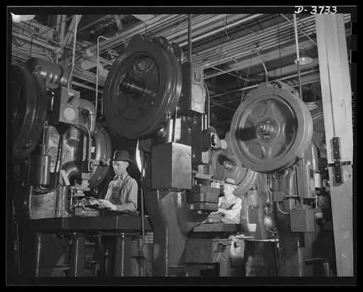 Stepping up jeep production. Fericute presses in a plant converted from the making of high-priced automobiles stamp out small parts for shipment to various assembly plants where tough little army cars are made. Ford Lincoln plant, Michigan