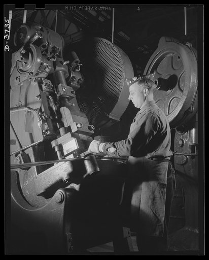 On the jeep production line. An incline press in a big automobile plant stamps out body parts for the versatile little army car. Assembly plants throughout the country finish the job. Ford Lincoln plant, Michigan