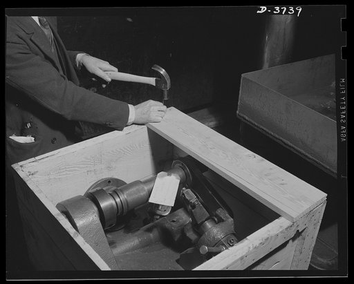 "In moth balls" until the Axis is smashed. A special machine tool that helped make a popular American automobile is crated for storage as all facilities of a big plant are converted for exclusive production of army "jeeps" and tanks. Ford Lincoln plant, Michigan
