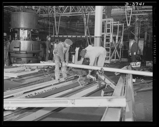 Converting to war production. Steel workers make structural changes as a big automobile plant is entirely changed over to volume production of army tanks and "jeeps." Ford Lincoln plant, Michigan