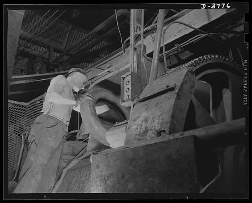 Rubber reclamation. Scrap tires, with beads removed, are fed to the "cracker," or grinding machine, of a big Midwest tire plant. The machine breaks the scrap tire into small pieces to facilitate removal of rubber from fabric by the xylos process. Firestone