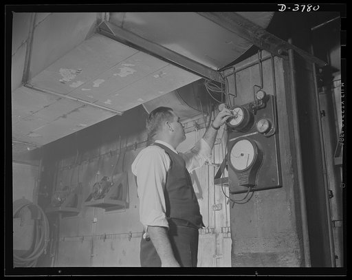 Rubber reclamation. Reclaiming rubber from scrap tires. An attendant at a large Midwest xylos process plant checks temperature on a continuous belt dryer which removes every trace of water. Recovery of rubber from old casings is based on dissolving and washing away all tire fibers and processing the