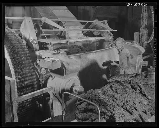Rubber reclamation. Rubber harvest from scrapped tires. Reclaimed, dried scrap rubber is plasticized on the eighty-four-inch mill roll of a xylos process plant in the Midwest. Pigments are added to give the properties desired in the finished product. As it comes off the mill rolls, the reclaimed sub
