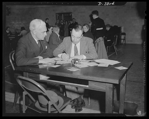 McNutt registers for draft. Paul V. McNutt, (FSA) Federal Security Administrator and recently-appointed chairman of the Manpower Commission, registers under the Selective Service Act at the Woodrow Wilson High School, Washington, D.C., April 25. Assisting him is Dr. William A. Killgore, draft regist
