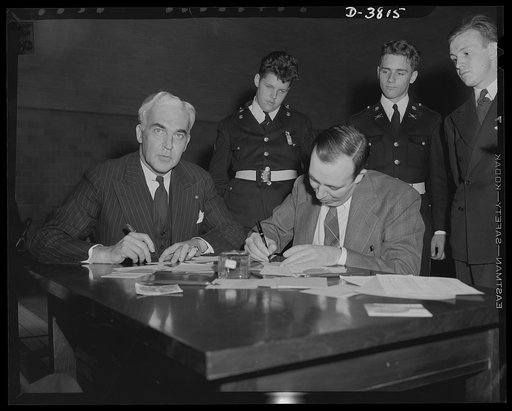 McNutt registers for draft. Paul V. McNutt, (FSA) Federal Security Administrator and recently-appointed chairman of the Manpower Commission, registers under the Selective Service Act at the Woodrow Wilson High School, Washington, D.C., April 25. Assisting him is Dr. William A. Killgore, draft regist