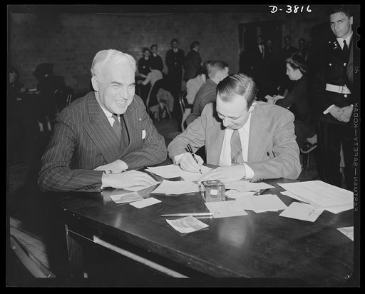 McNutt registers for draft. Paul V. McNutt, (FSA) Federal Security Administrator and recently-appointed chairman of the Manpower Commission, registers under the Selective Service Act at the Woodrow Wilson High School, Washington, D.C., April 25. Assisting him is Dr. William A. Killgore, draft regist
