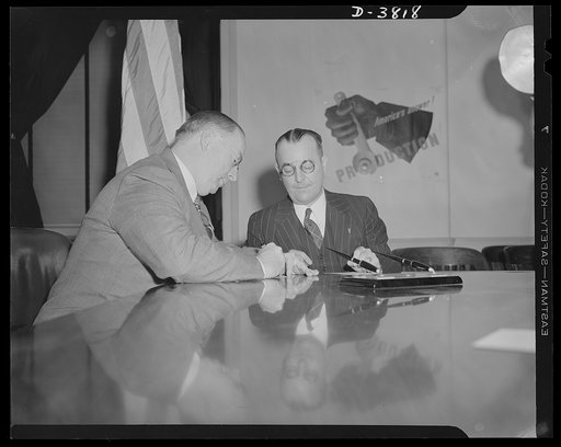 Nelson registers for draft. Donald Nelson, WPB (War Production Board) chief, registers under the Selective Service Act in the boardroom of the Social Security Building, April 27. Assisting him is James D. Hayes, chairman of local draft board No. 9, Washington, D.C.