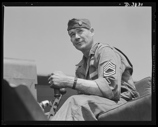YB-17 bombardment squadron, Langley Field, Virginia. When Uncle Sam's big bombers are grounded, they're in very capable hands. This master sergeant of a ground crew at Langley Field, Virginia is operating a tractor that tows the big aerial warships to the flying field