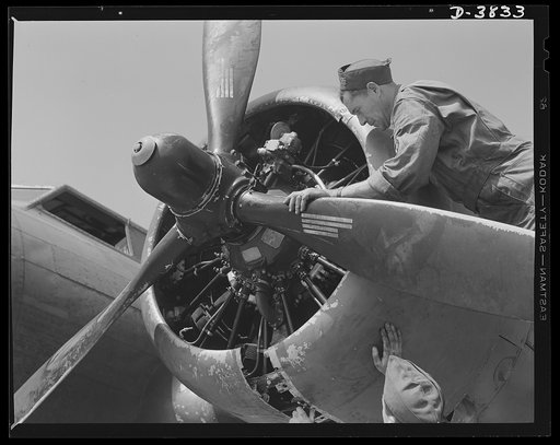 YB-17 bombardment squadron, Langley Field, Virginia. A master sergeant of a bombardment squadron at Langley Field, Virginia checks over a propeller adjustment job his soldier-mechanics have just made on a big YB-17 bomber