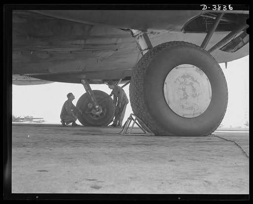 YB-17 bombardment squadron, Langley Field, Virginia. The enormous size of the landing wheels of a YB-17 bomber can be appreciated when compared with the sizes of the two men inspecting the landing gear. The men, a staff sergeant and a technical sergeant, belong to a bombardment squadron at Langley F