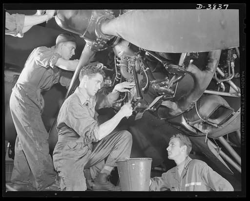YB-17 bombardment squadron, Langley Field, Virginia. Tuning a bomber engine requires knowledge and skill. These three corporals of a bombardment squadron at Langley Field, Virginia are making adjustments that will put a mighty YB-17 bomber in the pink of condition