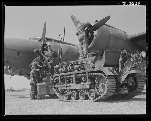 YB-17 bombardment squadron, Langley Field, Virginia. The engines of the mighty YB-17 bombers are always in the pink of condition. This crew of soldier-mechanicas at Langley Field, Virginia is making one of the regular changes of spark plugs that insure peak performance